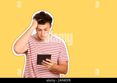 Young shocked student working on a digital tablet and holding on to head. emotional guy isolated Magazine collage style with trendy color. Stock Photo