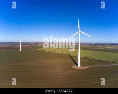 Aerial view of two wind turbines on a field Stock Photo