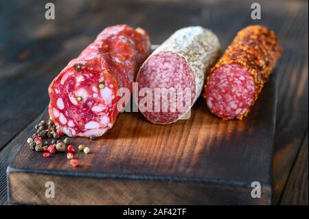 Assortment of salami on the wooden board Stock Photo