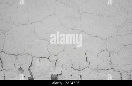 Cracked concrete grey wall covered with gray cement texture as background can be used in design. Dirty concrete texture with cracks and holes. Stock Photo