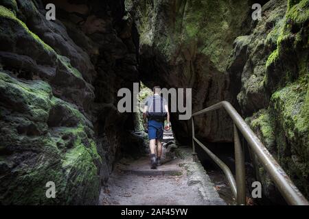 A hiker walks up the path to the Bastei Bridge. Stock Photo