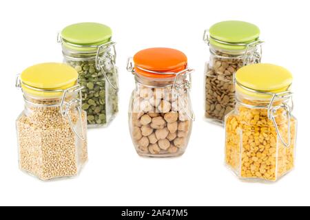 The collection of different groats in the glass jars isolated on white background. Split peas, quinoa, chickpea and lentils. Stock Photo