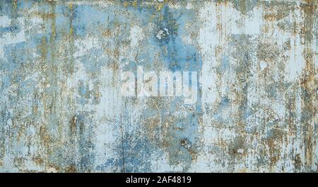 Painted in blue metal rusted background. Metal rust texture. Erosion metal. Scratched and dirty texture on outdoor rusted metal wall. Stock Photo
