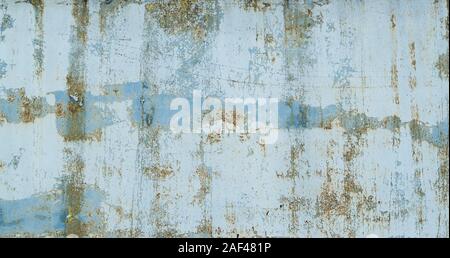 Painted in blue metal rusted background. Metal rust texture. Erosion metal. Scratched and dirty texture on outdoor rusted metal wall. Stock Photo