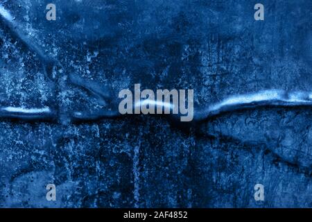 Crumpled and scratched metal texture in trendy blue color. Color of the year 2020 concept. Mockup for your design. Abstract background. Copy space. Stock Photo
