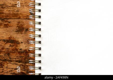 Top view image of blank open notebook page with spiral ring on dark wooden background with copy space. For use as mock up Stock Photo