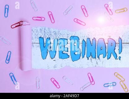 Conceptual hand writing showing Webinar. Concept meaning seminar or other presentation types that takes place on Internet Paper clip and torn cardboar Stock Photo