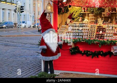 Vendor and Christmas elf at Manta Christmas market, Mantan joulumarkkinat, at Havis Amanda square by Kauppatori, Helsinki, Finland. December 10, 2019. Stock Photo