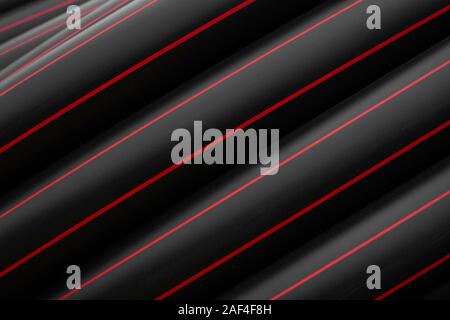 Pipe Red Line Black rubber or plastic pipes with a red lines as a construction ...