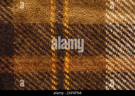 Brown checked fabric. Scottish wool. Fabric for coat plaid suit. Close-up. Background Stock Photo