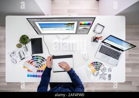 Close-up Of A Designer's Hand Editing Photo On Computer In Office Stock Photo