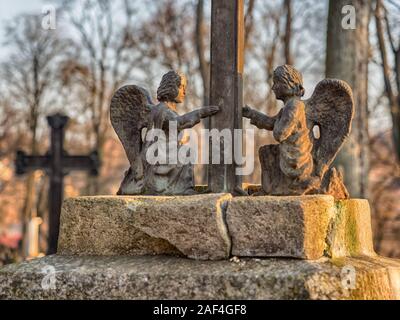 Užupis, Vilnius, Lithuania - April 08, 2018: Bronze Angels on a tomb on local  cemetery in Vilnus, Europe Stock Photo
