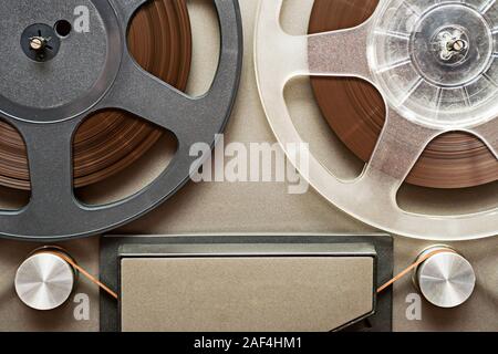 Vintage tape recorder is playing music, close up. Vintage tape recorder roller. Stock Photo