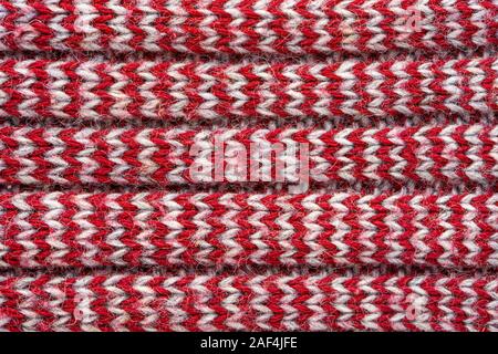 Knitted sweater texture. White and burgundy pattern. Background. Copy space Stock Photo