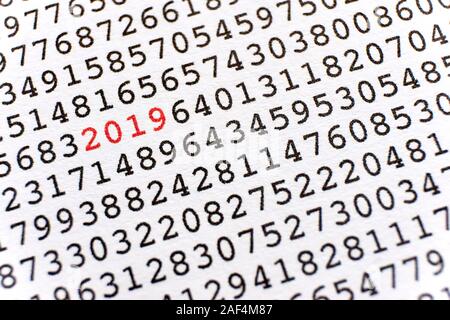 Background with black printed random numbers and the numbers 2019 in red for use as a template for a new year card or annual report. Stock Photo