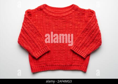 Kids knitted sweater with pattern. Beautiful red woolen autumn sweater with long sleeves. Front view. On white background Stock Photo