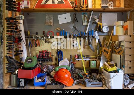 Mess and tools in disorder in a workroom. Equipment, home, interior, rope, dirty, house, messy, objects, stuff, box, chaos, clutter, cluttered Stock Photo