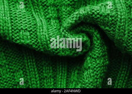 Knitted Sweater Background Twisted into a Spiral. Green mottled pattern. Facial surface. Copy space Stock Photo