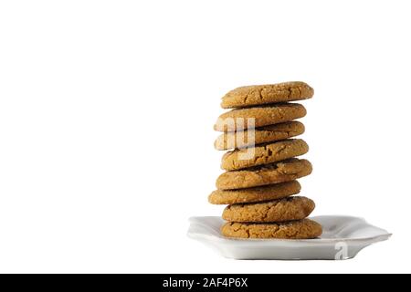 A stack of gingerbread cookies on a white plate isolated on white background with copy space; landscape Stock Photo