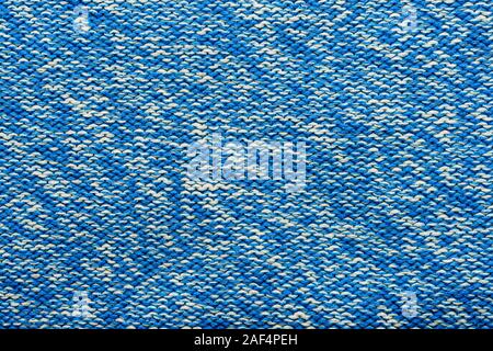 The texture of a knitted sweater. Blue white mottled pattern. Facial surface. Background. Copy space Stock Photo