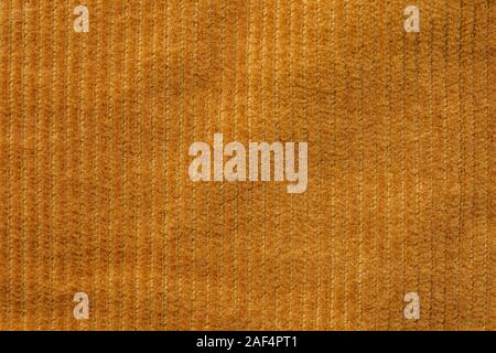 Texture of corduroy velvet fabric close-up. Texture of rufous velvet clothes. Textile fabric as background Stock Photo