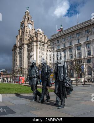 Liverpool, United Kingdom - 17 March 2019: Bronze statue of the Beatles standing on Liverpool’s Pier Head waterfront, sculpted by Andrew Edwards Stock Photo