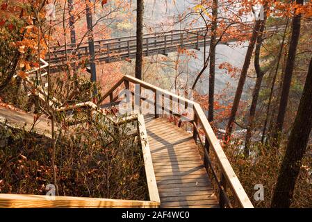 Wooden walkway leading towards a suspension bridge that crosses over the Tallulah River in Tallulah Falls Georgia USA. Stock Photo