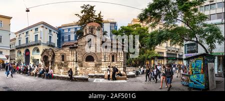 People sitting around the old church of Panagia Kapnikarea in Monastiraki, Greece Stock Photo