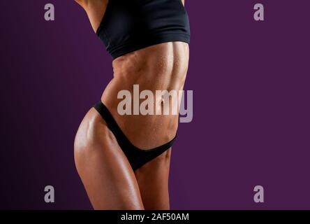 Female Fitness Trainer Showing Off Her Muscular Abs Stock Photo