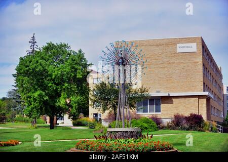 Whitewater, Wisconsin, USA. Modern sculpture on the campus of the University of Wisconsin Whitewater provides a foreground for White Hall. Stock Photo