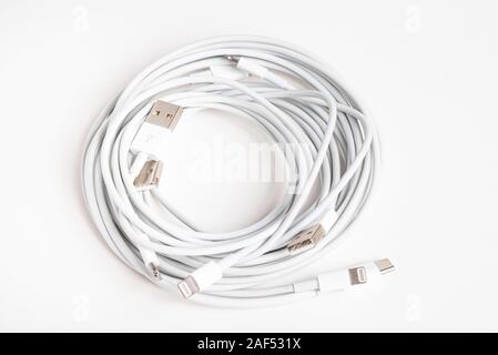 Vidalia, Georgia / USA - September 8, 2019: Several white Apple power cables and connectors in an organized swirl on plain white background. Stock Photo