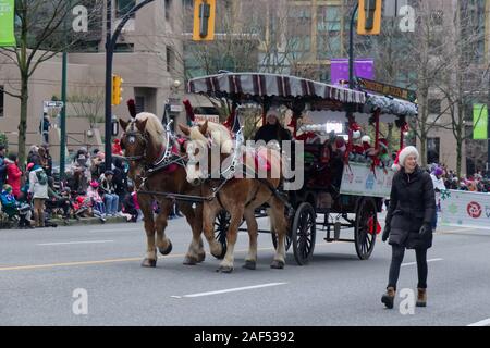 Vancouver, Canada - December 1, 2019: Stanley park horse drawn tours company takes part in the annual Santa Claus Parade In Vancouver Stock Photo