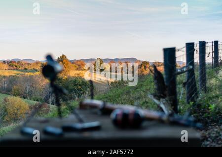 rifle and spotting scope on table out of focus at outdoor range in Kentucky Stock Photo