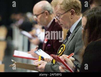 Glasgow, UK. 12 December 2019.Pictured: Candidates checking and recording the vote counting.  Scenes from the vote count at the Scottish Exhibition and Conference Centre (SECC). The poles have now closed at 10pm and the vote count is now underway for the UK Parliamentary General Election 2019. This is the first time in almost 100 years that a general election has taken place in December. Credit: Colin Fisher/Alamy Live News. Stock Photo