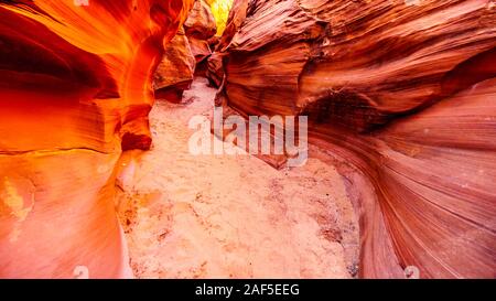 Smooth curved Red Sandstone walls caused by water erosion in Mountain Sheep Canyon. It is a famous Slot Canyons in the Navajo lands near Page, AZ, USA Stock Photo