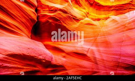 Smooth curved Red Sandstone walls caused by water erosion in Mountain Sheep Canyon. It is a famous Slot Canyons in the Navajo lands near Page, AZ, USA Stock Photo