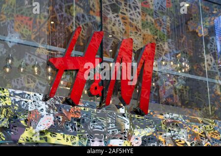 Brisbane, Queensland, Australia - 19th November 2019 : View of an H&M Logo hanging on a glass wall at the shop entrance in Queenstreet Mall in Brisban Stock Photo