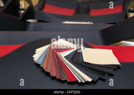 A catalog with samples of genuine leather materials in different colors for the manufacture of designer clothes, shoes and accessories. Stock Photo