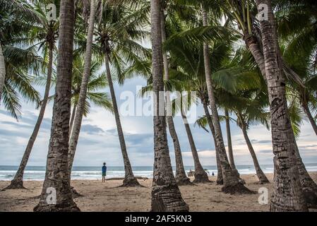 A boy stands on the beach at Playa Grande Costa Rica Stock Photo