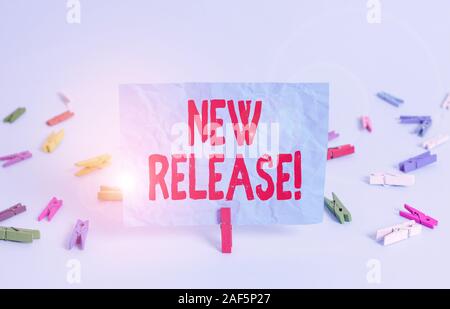 Writing note showing New Release. Business concept for announcing something newsworthy recent product Colored clothespin rectangle square shaped paper Stock Photo