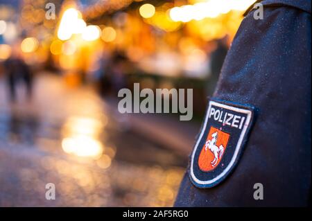 11 December 2019, Lower Saxony, Lüneburg: A policeman is standing on one of Lüneburg's Christmas markets. (to dpa 'Mustard trick and tree theft: Crime scene Christmas market') Photo: Philipp Schulze/dpa Stock Photo