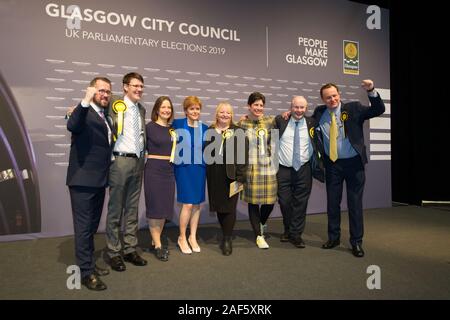 Glasgow, UK. 13th Dec, 2019. Pictured: (in blue) Nicola Sturgeon MSP - First Minister of Scotland and Leader of the Scottish National Party (SNP); standing along with hre winning candidates. Scenes from the vote count at the Scottish Exhibition and Conference Centre (SECC). The poles have now closed at 10pm and the vote count is now underway for the UK Parliamentary General Election 2019. This is the first time in almost 100 years that a general election has taken place in December. Credit: Colin Fisher/Alamy Live News Stock Photo
