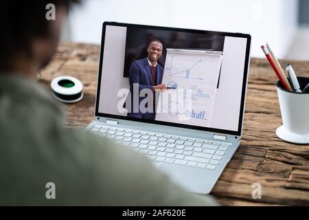 Man Participating In Online Coaching Session Using Laptop Stock Photo