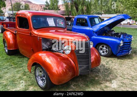 A restored and modified 1938 Chevy Pickup Truck in the Moab April Action Car Show in Moab, Utah.  Next to it is a blue1951 Chevy 3100 Pickup Truck. Stock Photo