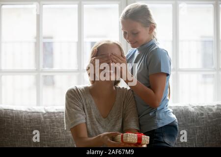 Caring daughter make birthday surprise for young mom Stock Photo
