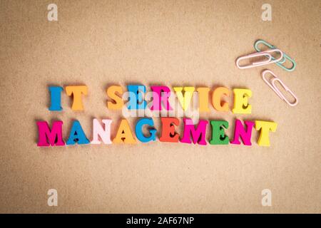 It Service Management. Text from colorful wooden letters on cardboard background Stock Photo