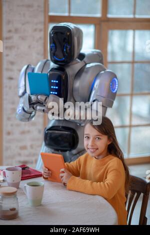 Robot with a tablet in his hands making pictures Stock Photo