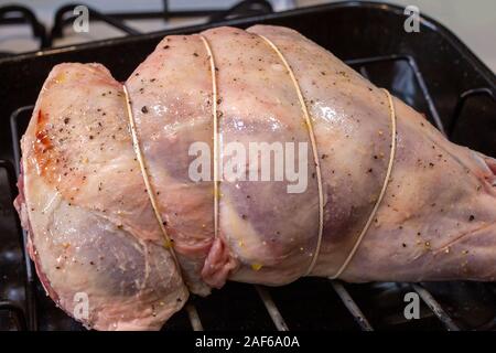 Leg of lamb stuffed and trussed in preparation for roasting Stock Photo