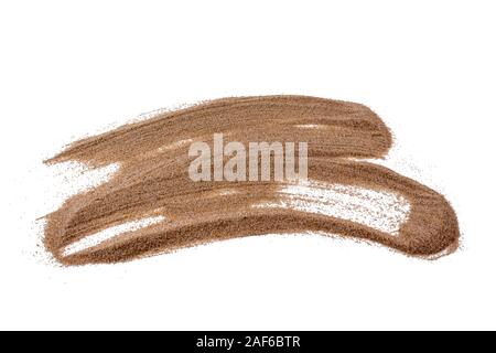 Beautiful sand smear. Sand painting. Scattered beige oceanic fine sand isolated on white background. Top view. Stock Photo
