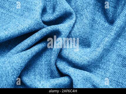 Draped woolen scarf - fabric background toned classic blue color Stock Photo